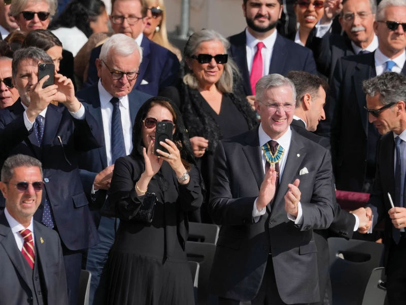 Supreme Knight Patrick Kelly, with his wife, Vanessa, at his side, applauds as Pope Leo XIV arrives