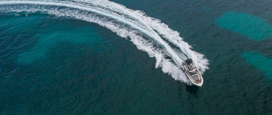 Aerial view of powerboat at speed steering to starboard