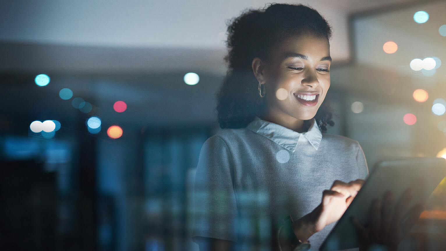 Image of a woman looking at an electronic tablet.