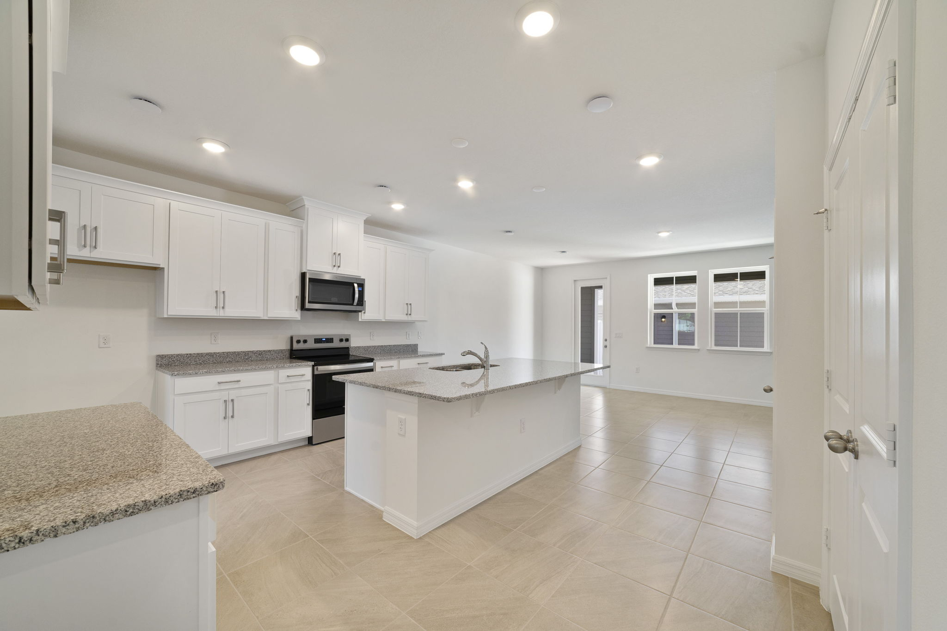 granite center island and stainless-steel appliances  