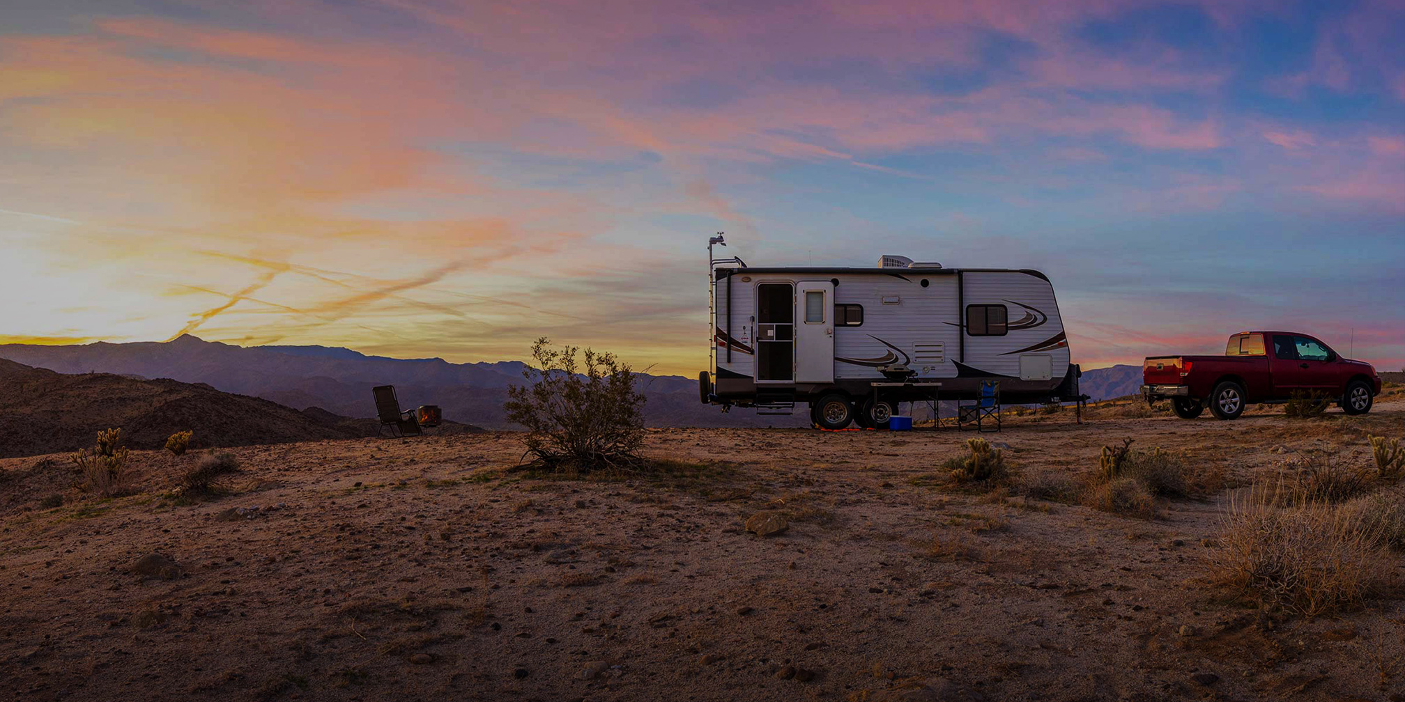 RV trailer with onboard Fathom e-power system in desert at sunset