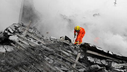 Firefighter doing recovery in destroyed building