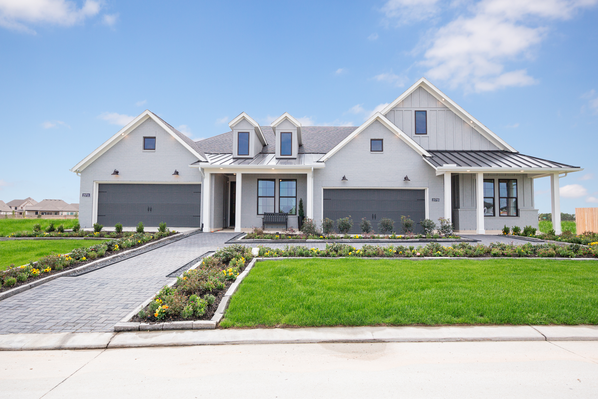 exterior brick dual homes with gray garage doors 