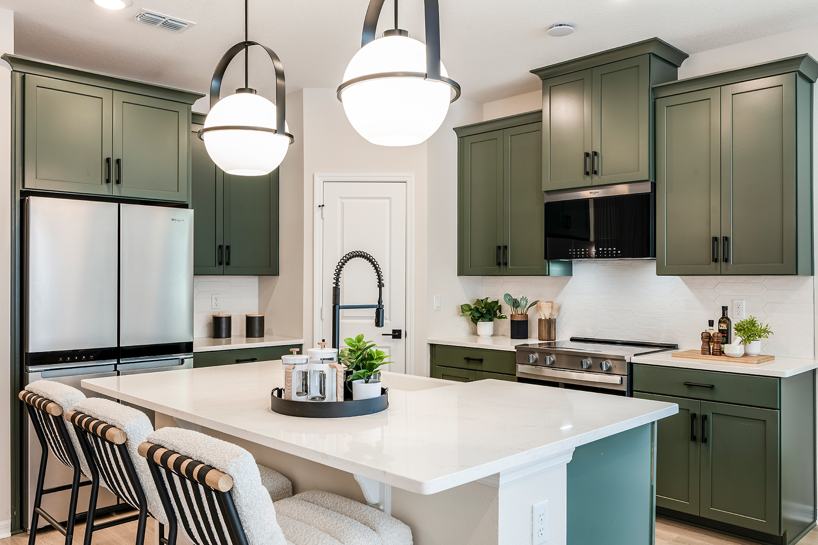 kitchen with green cabinets and quartz countertops