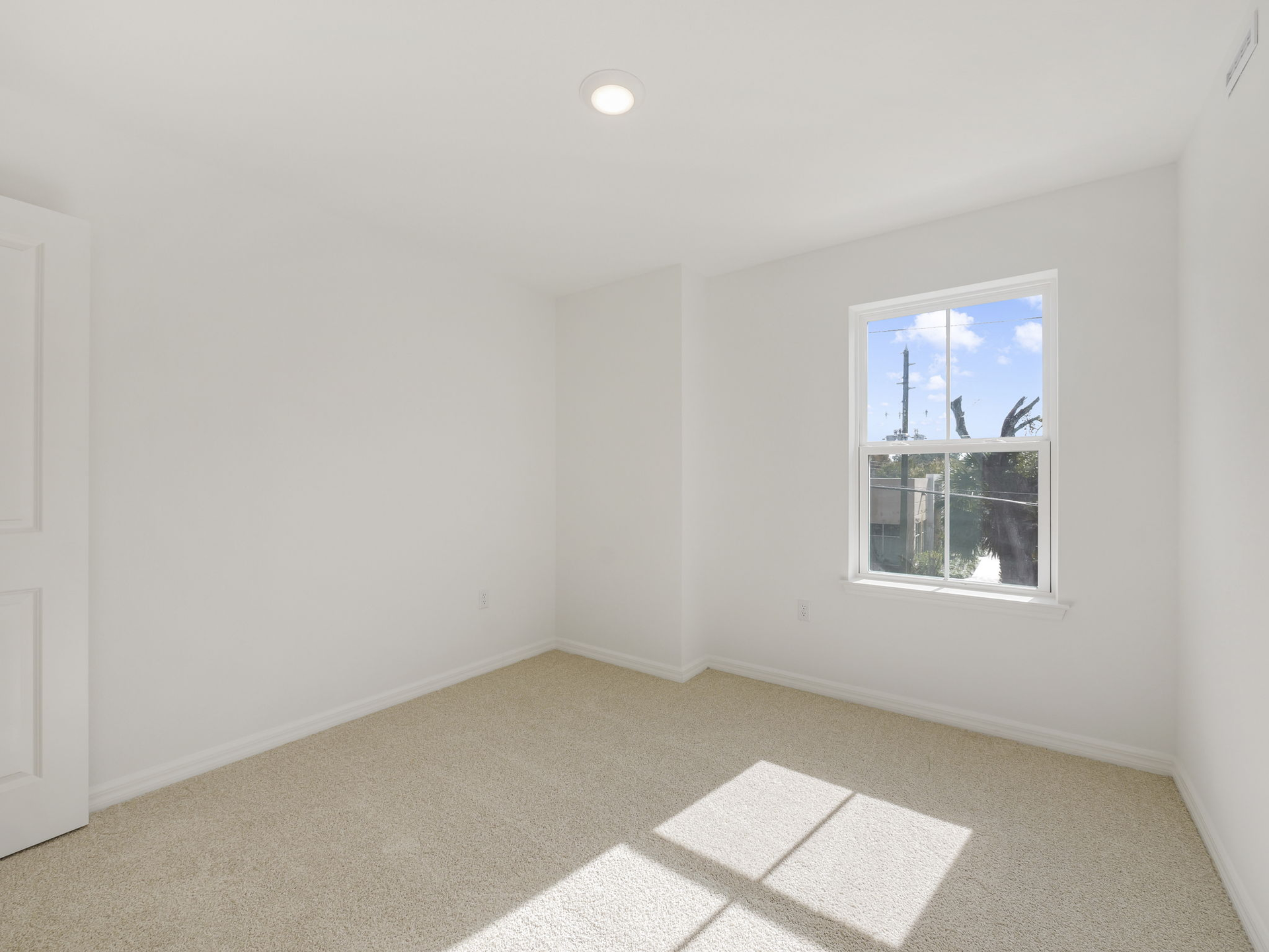 third bedroom with carpet and one window