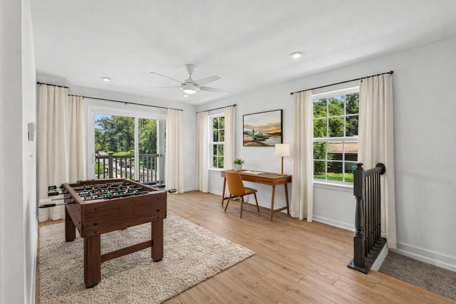 loft with a desk and foosball table