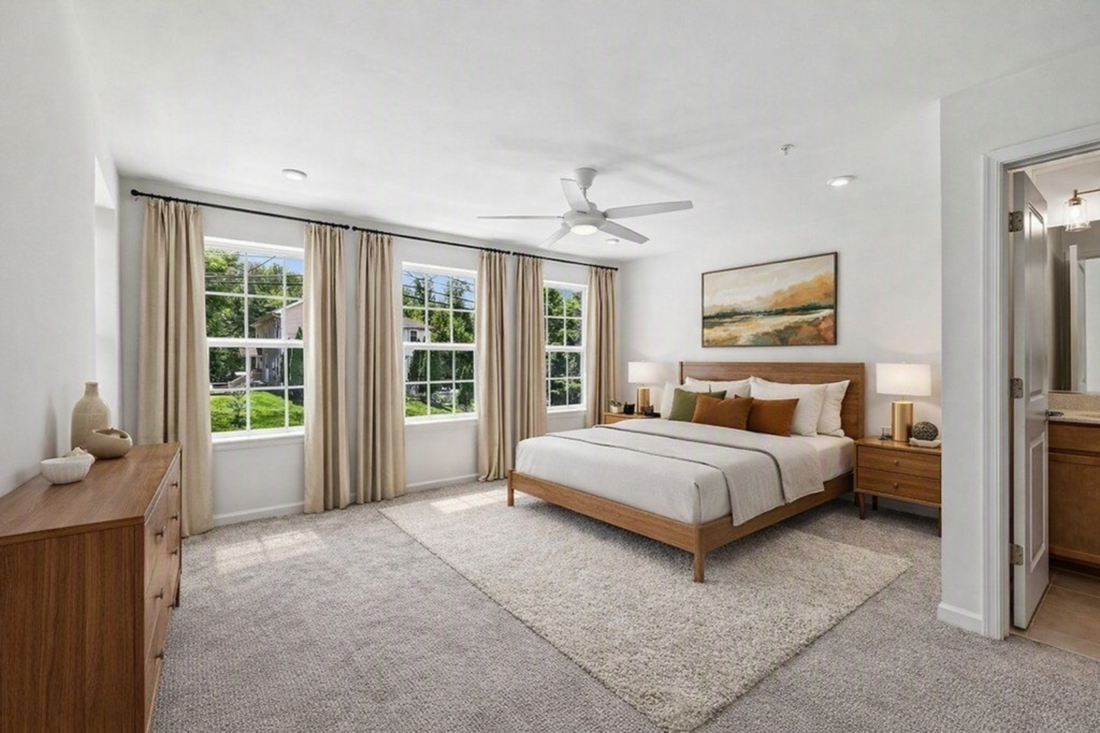 primary suite with a king-size bed and carpet