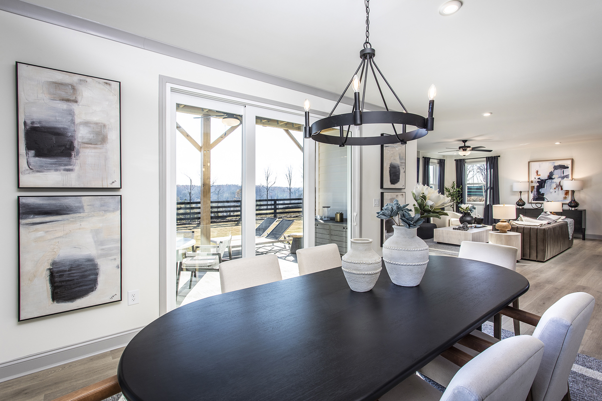 dining room with black table & windows