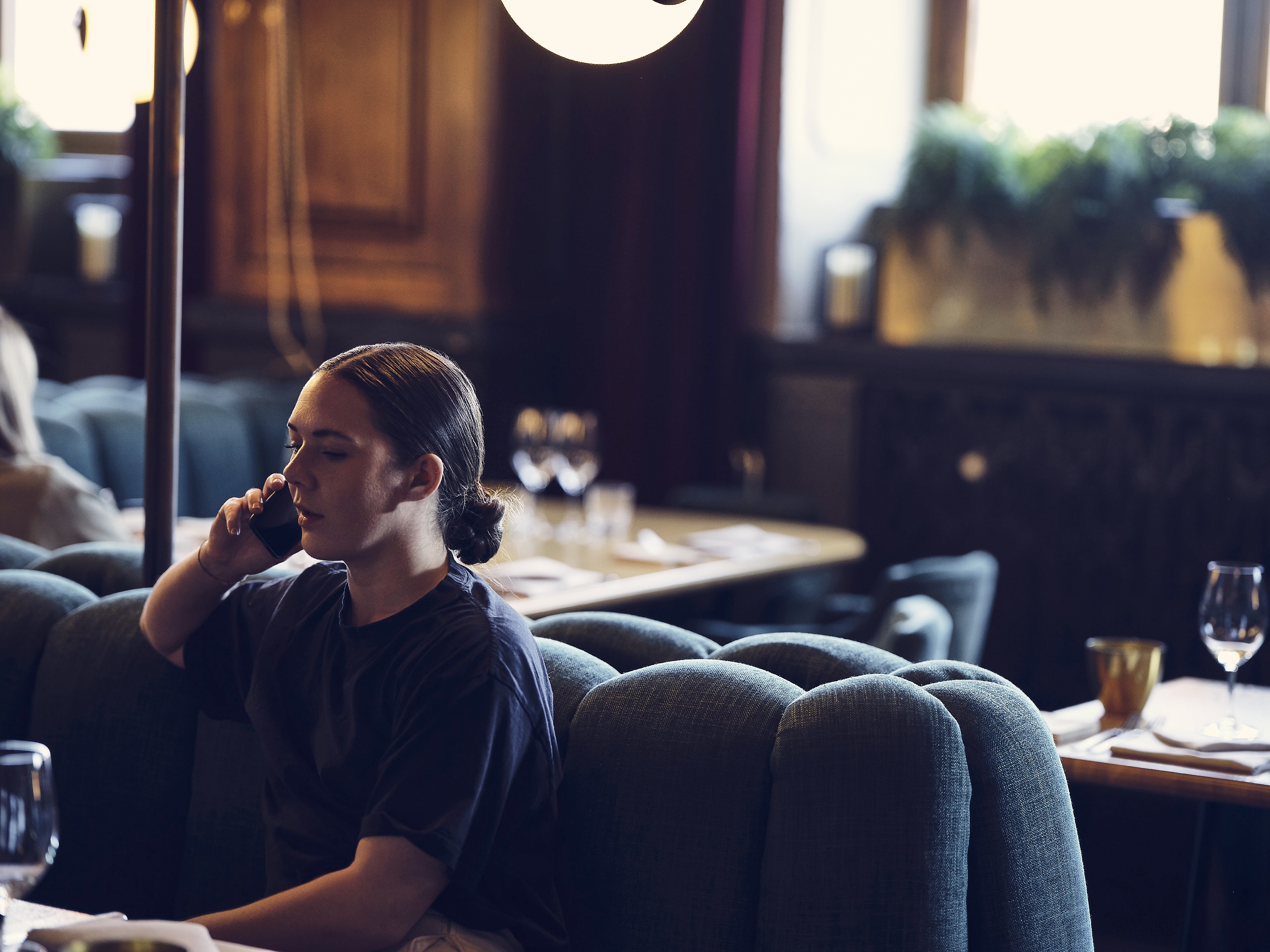 Woman in restaurant talking on the phone