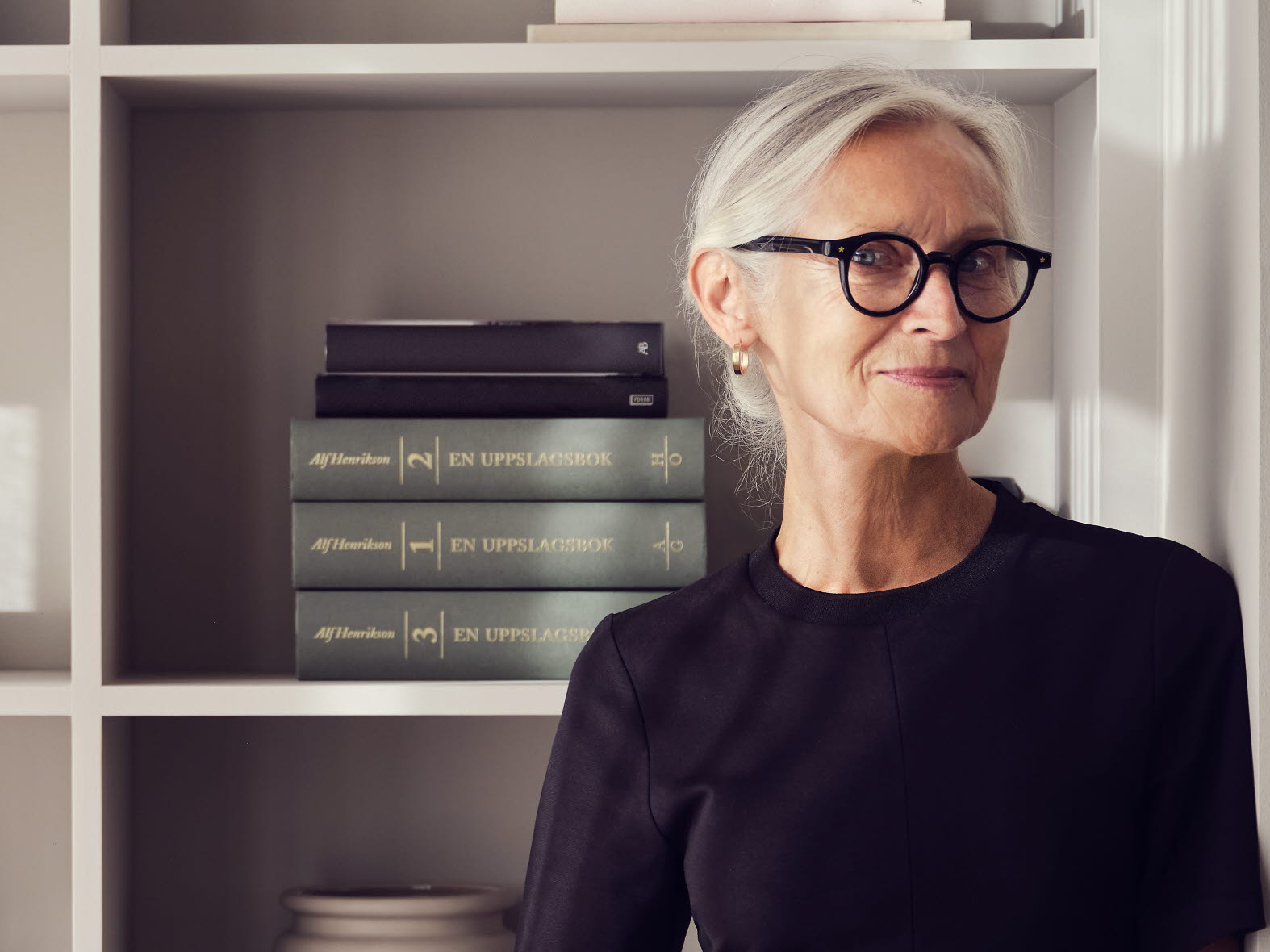 Woman in front of a book shield
