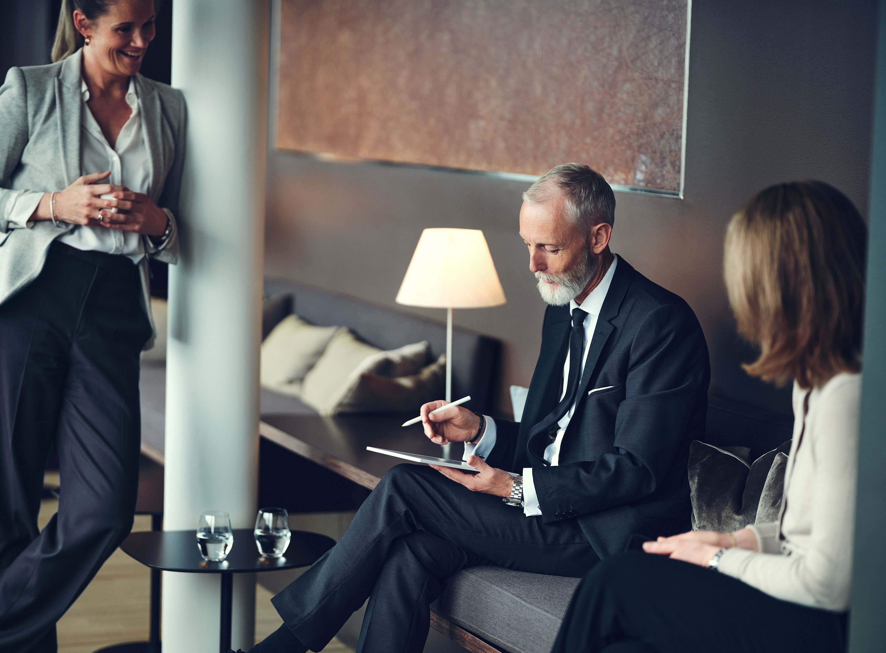 Three people discussing in a coffee corner