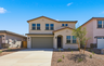 two-story single-family home with desert landscaping and concrete driveway