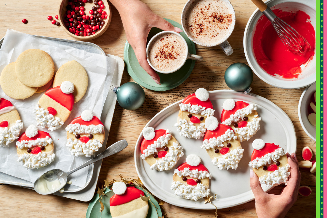 Cookies decorated with red and white icing to make cute Santa faces. Accompanied with hot chocolates. 