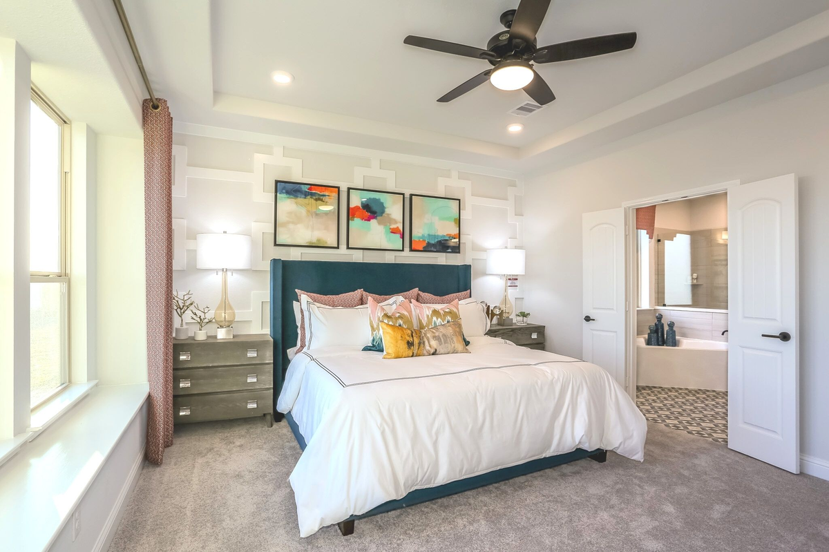 primary bedroom with carpet floors and ceiling fan