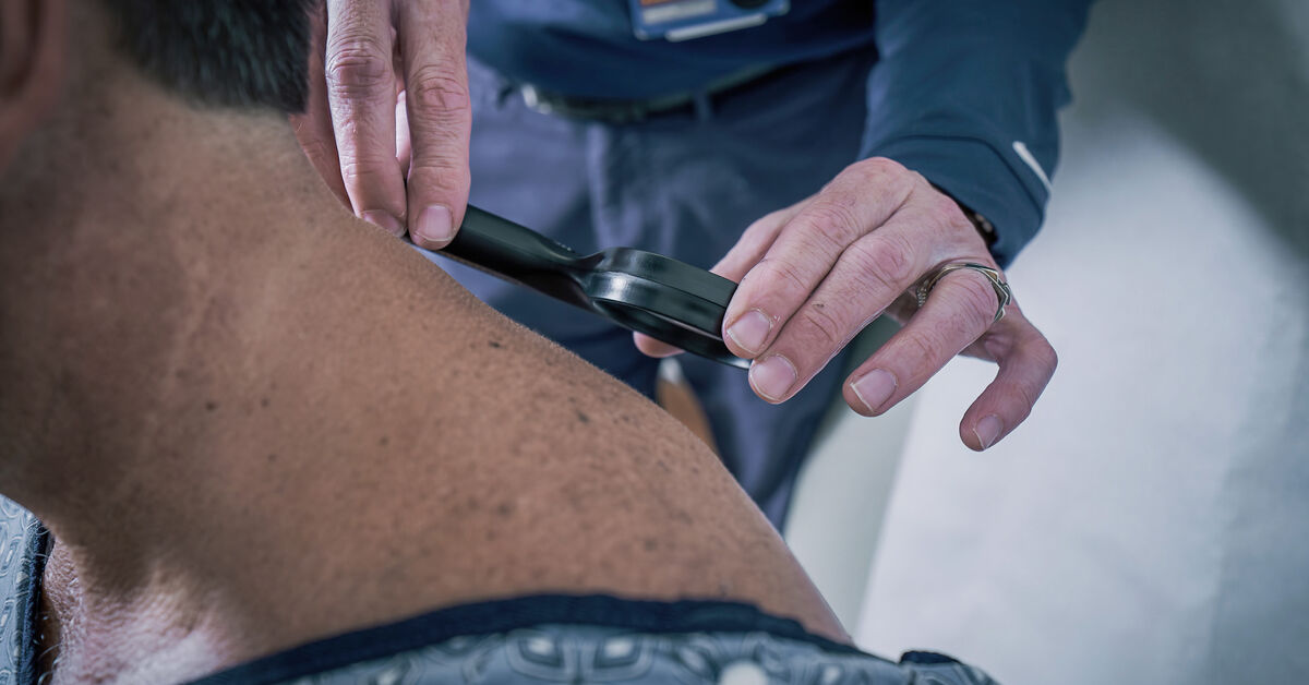 Doctor checks patient's skin for cancer