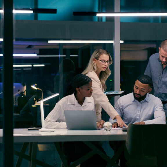 Professional team brainstorming in an office at night