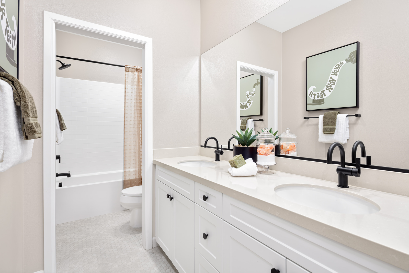 secondary bathroom with two sinks and large mirror