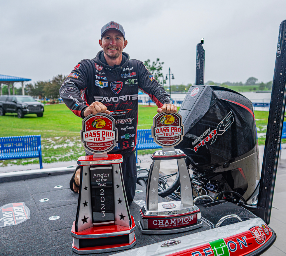 Matt Beckler celebrating with two angler trophies