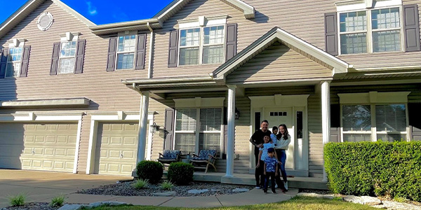 The Braga family in front of their house