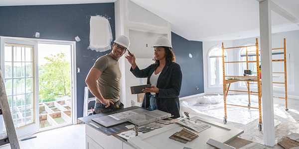 A man and a woman are renovating a home.