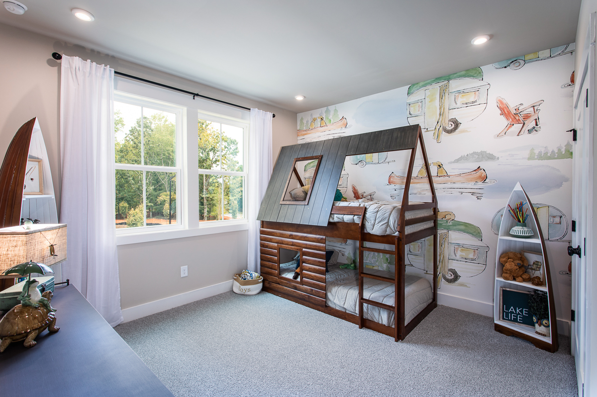 secondary bedroom with bunkbed and neutral carpet