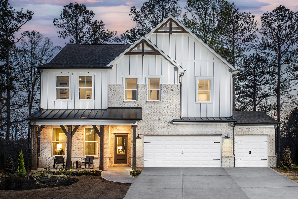 front of home with brick detail and white siding