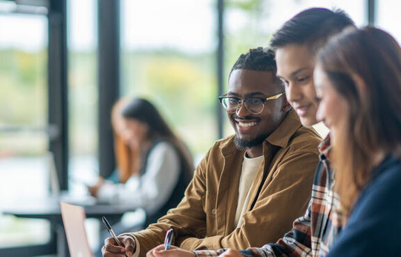 University students are sitting together in class assignment