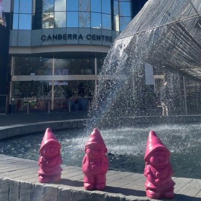 image of three little pink gnomes next to fountain outside Canberra Centre