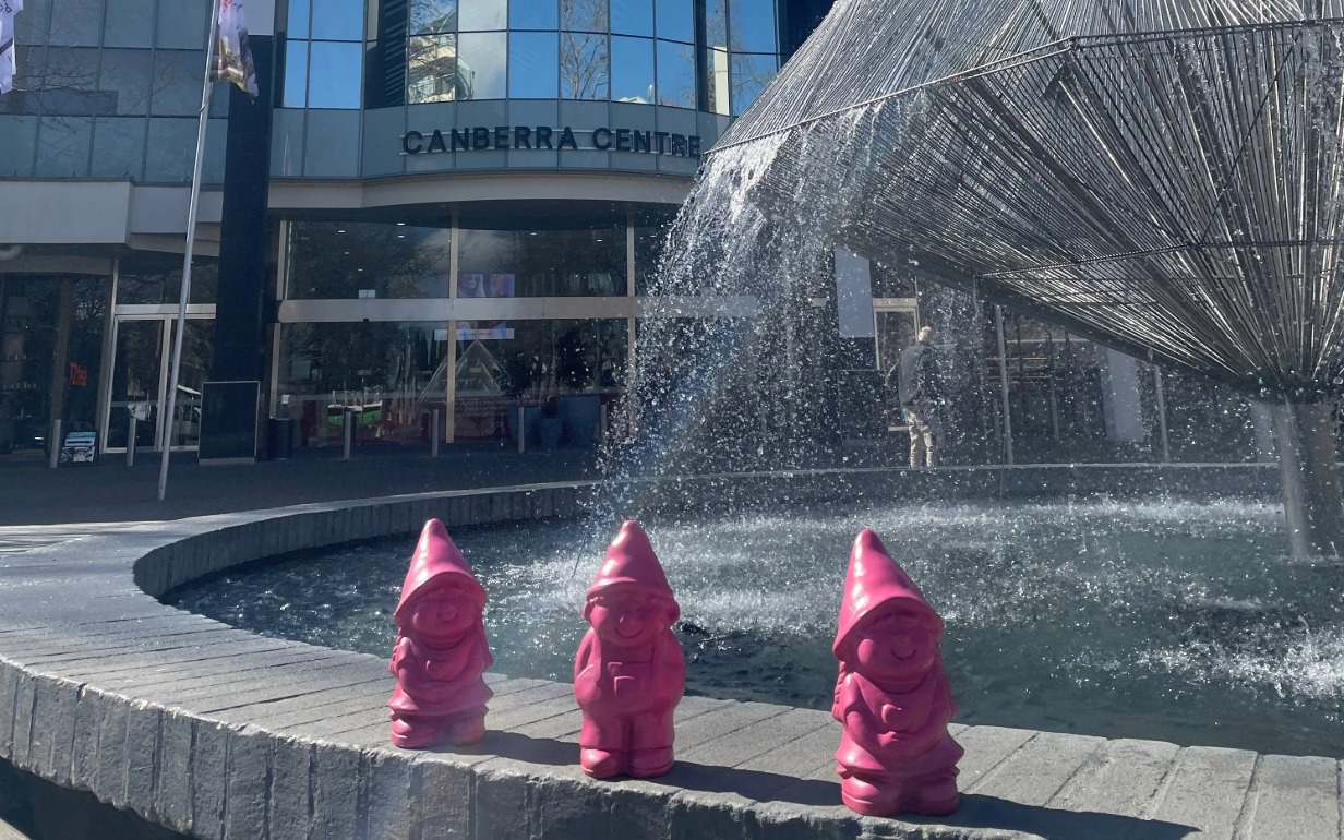 image of three little pink gnomes next to fountain outside Canberra Centre