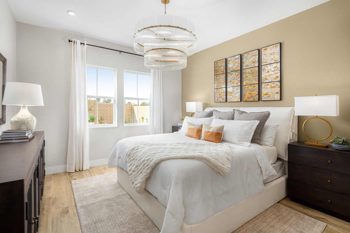 bright primary bedroom with chandelier 