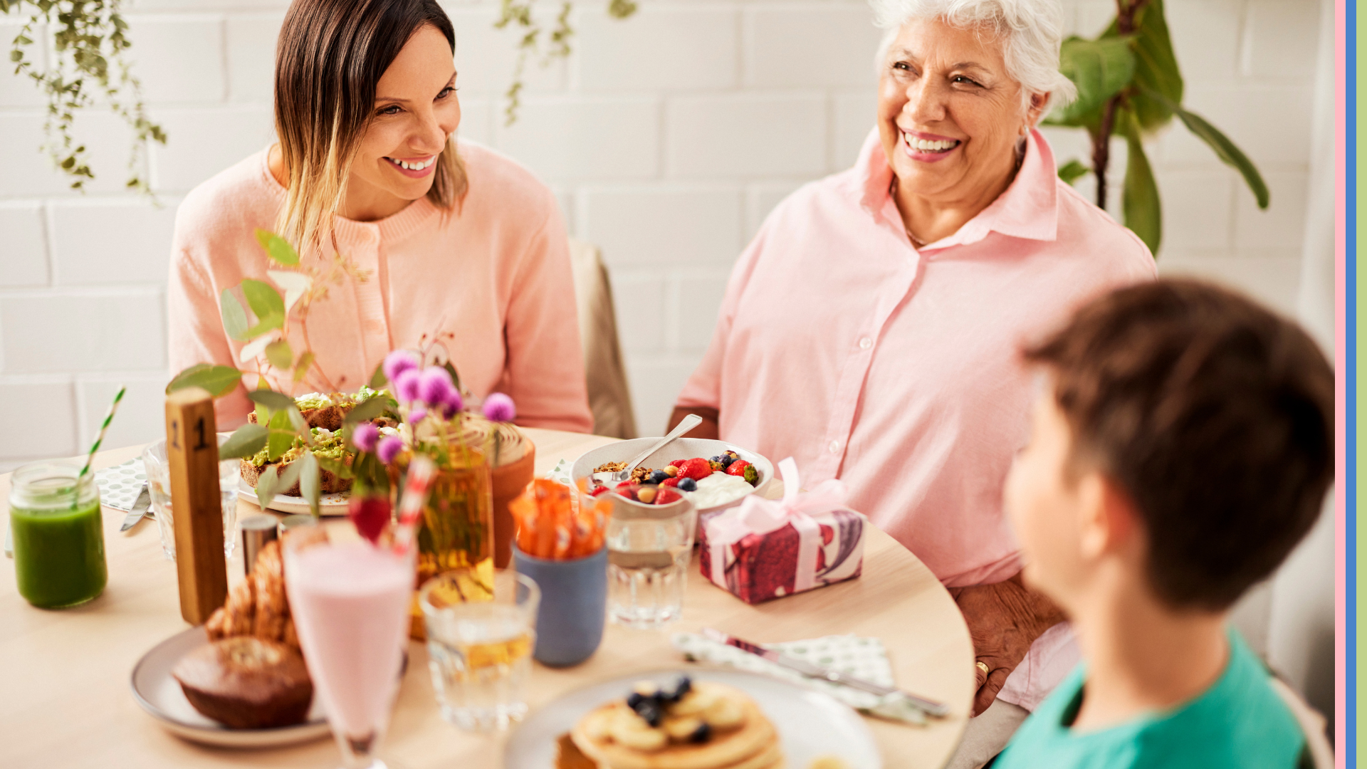 Two mums laughing together over Mother's Day brunch with their son / grandson