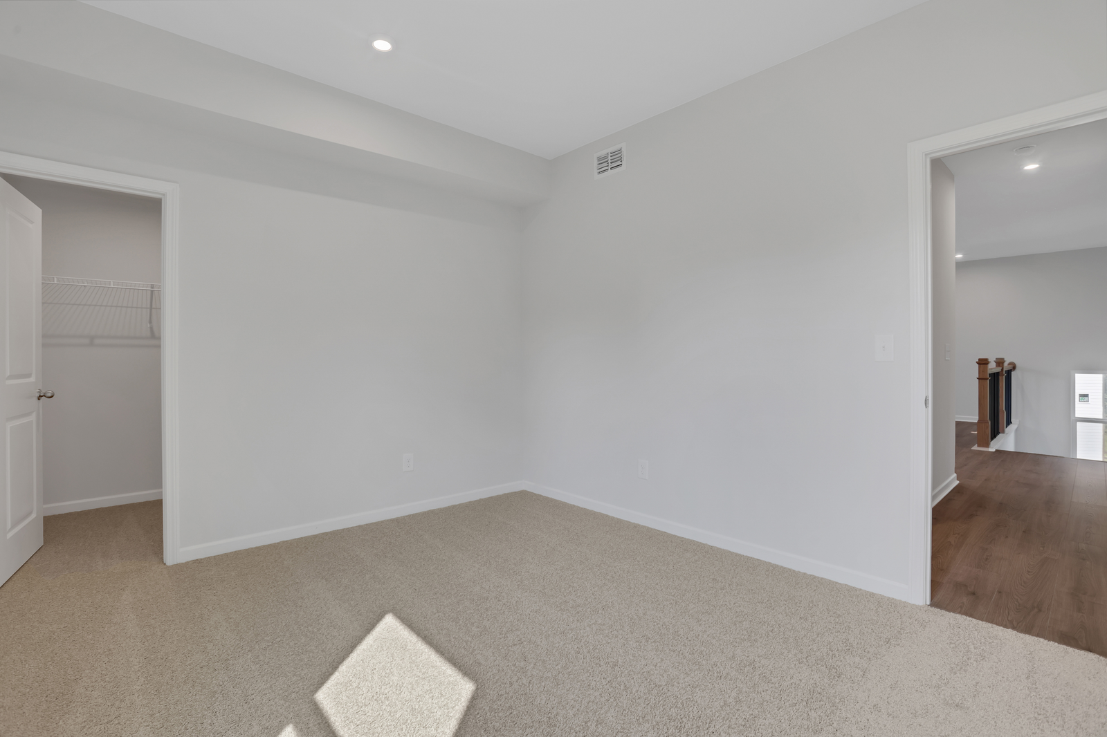 secondary bedroom with windows and carpet