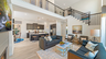 great room with wood flooring, two-story ceiling, and a fireplace
