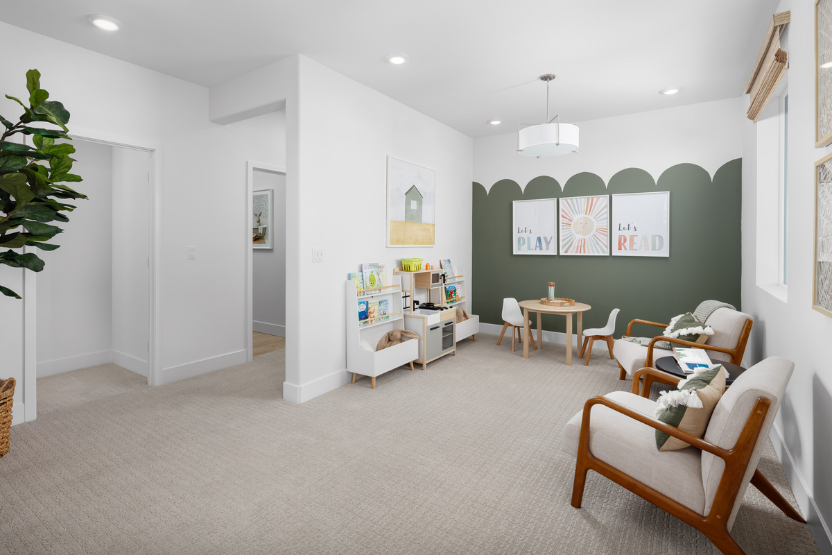 loft with green wall and kids table & chairs