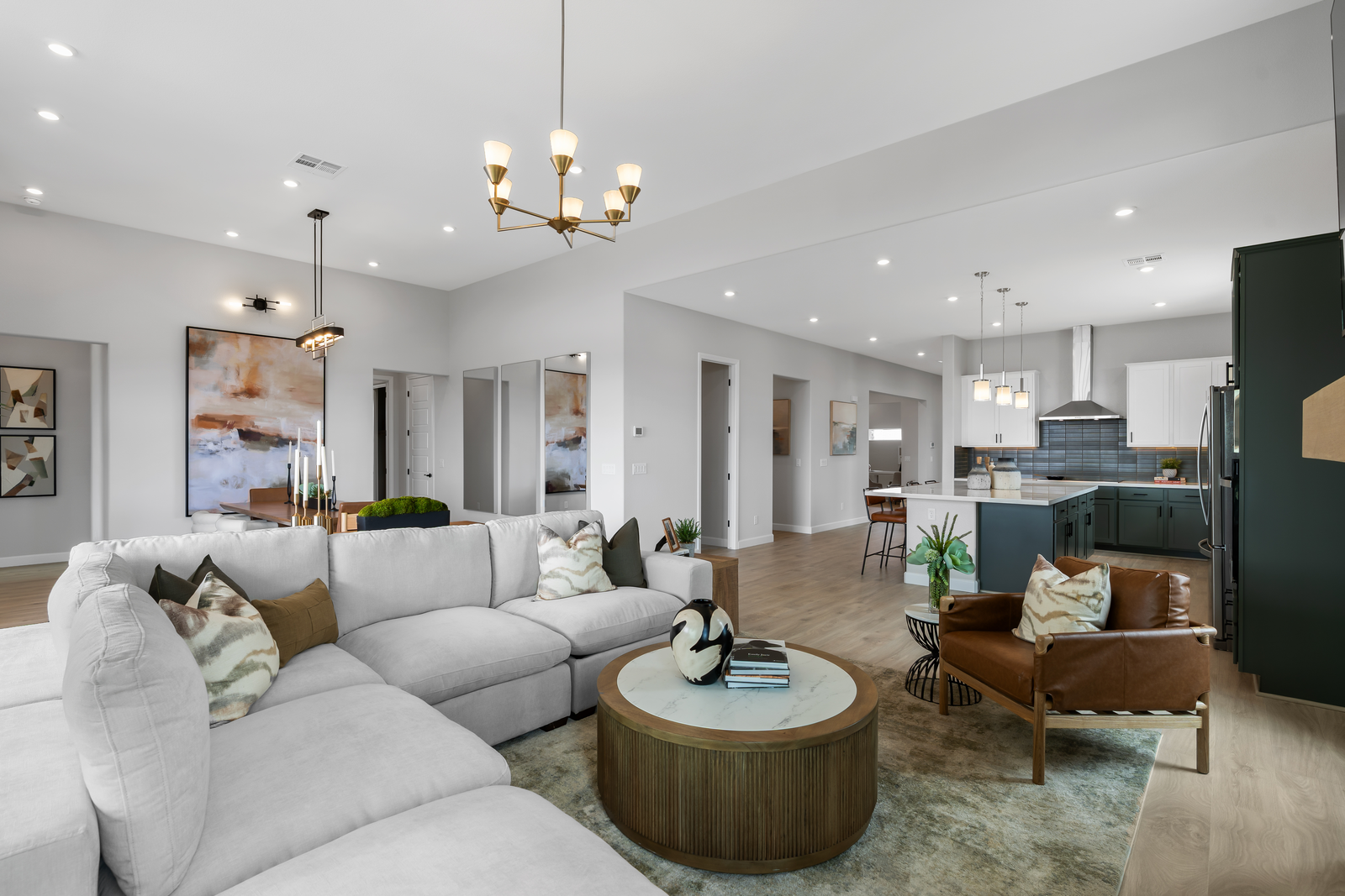 great room with grey couch and two-tone cabinets