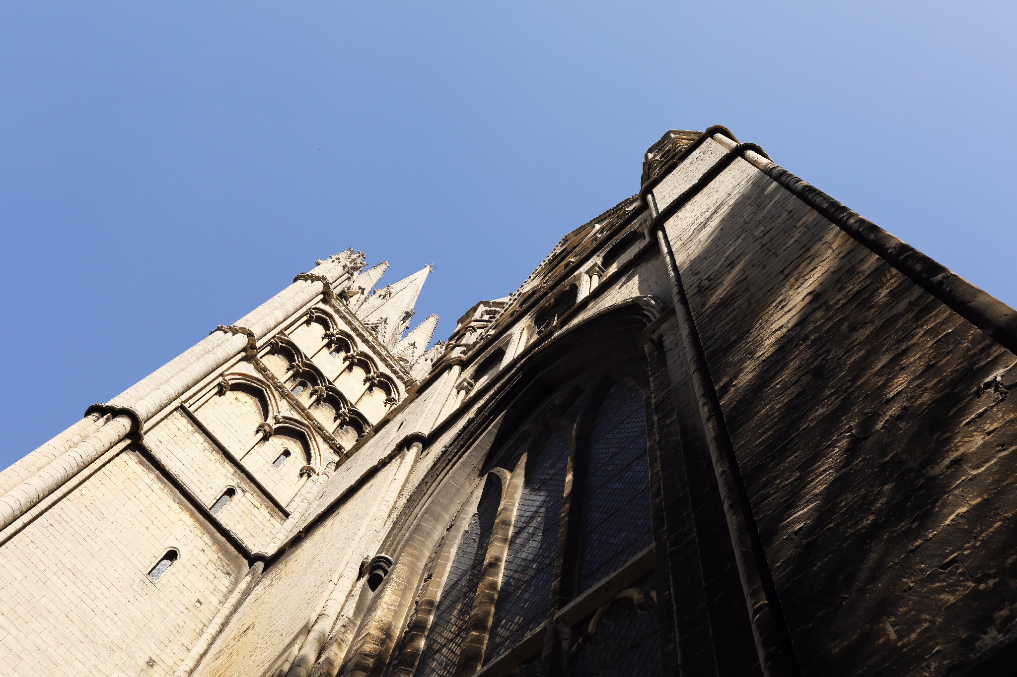 Worm's-eye view of the cathedral's stone exterior and towers
