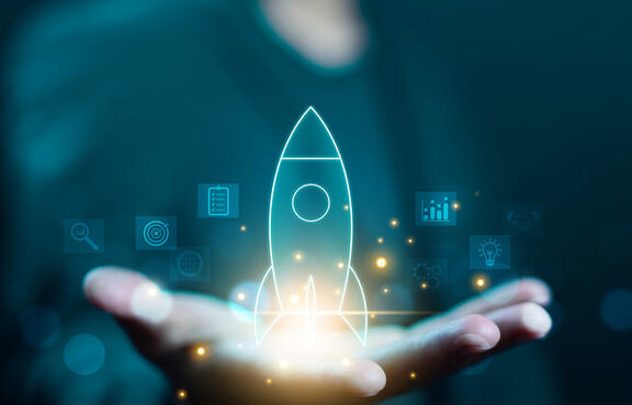 man holding a digital rocket ship in his hand 