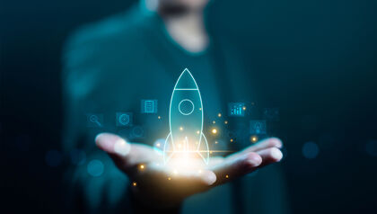 man holding a digital rocket ship in his hand 