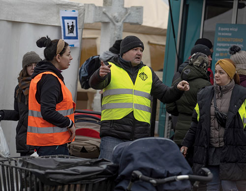 Marcin Wojciechowski, grand knight of St. Wojciech Patron of Poland Council 15267, directs volunteers at the Ukraine border crossing in Hrebenne, Poland