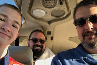 Father Gervan Menezes, chaplain of Blessed Pier Giorgio Frassati Council 15020 in Nashville, Tenn., carries the Blessed Sacrament in the backseat of Daniel Schachle’s Piper Archer plane