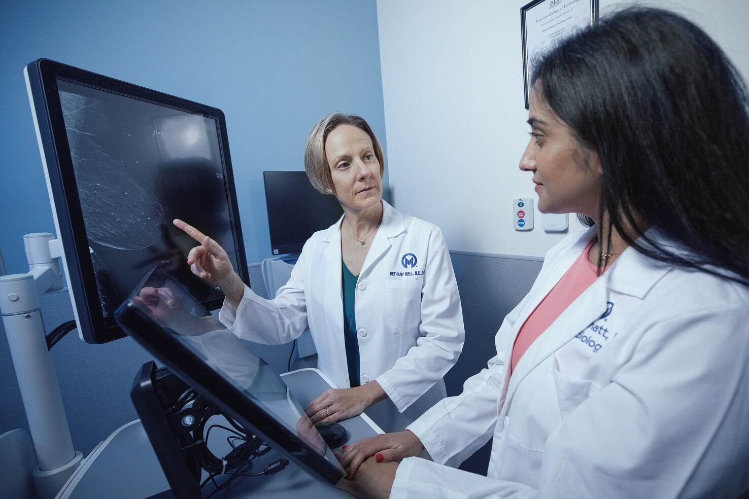 Dr. Bethany Niell reviews a patient's breast scans prior to treatment