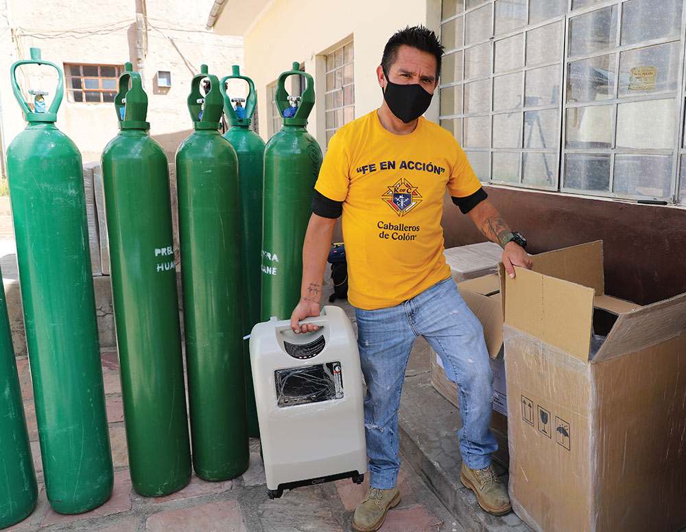 A volunteer unpacks one of the oxygen 