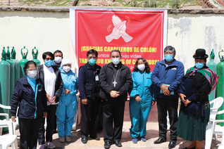Bishop Giovanni Cefai of the Territorial Prelature of Santiago Apóstol de Huancané in Peru (center) stands with health care workers from the province of Puno, Feb. 26, after blessing oxygen cylinders donated by the Knights of Columbus