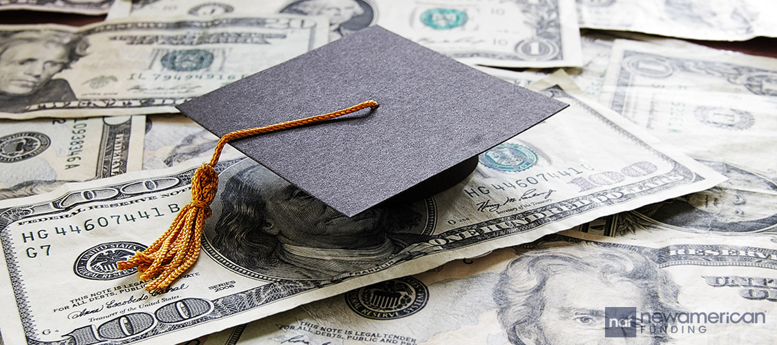 graduation cap on top of money