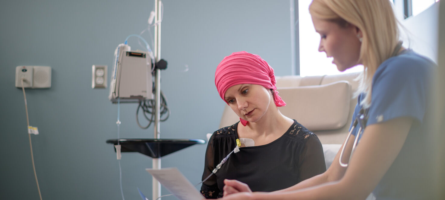 Nurse describes chemotherapy treatment to patient