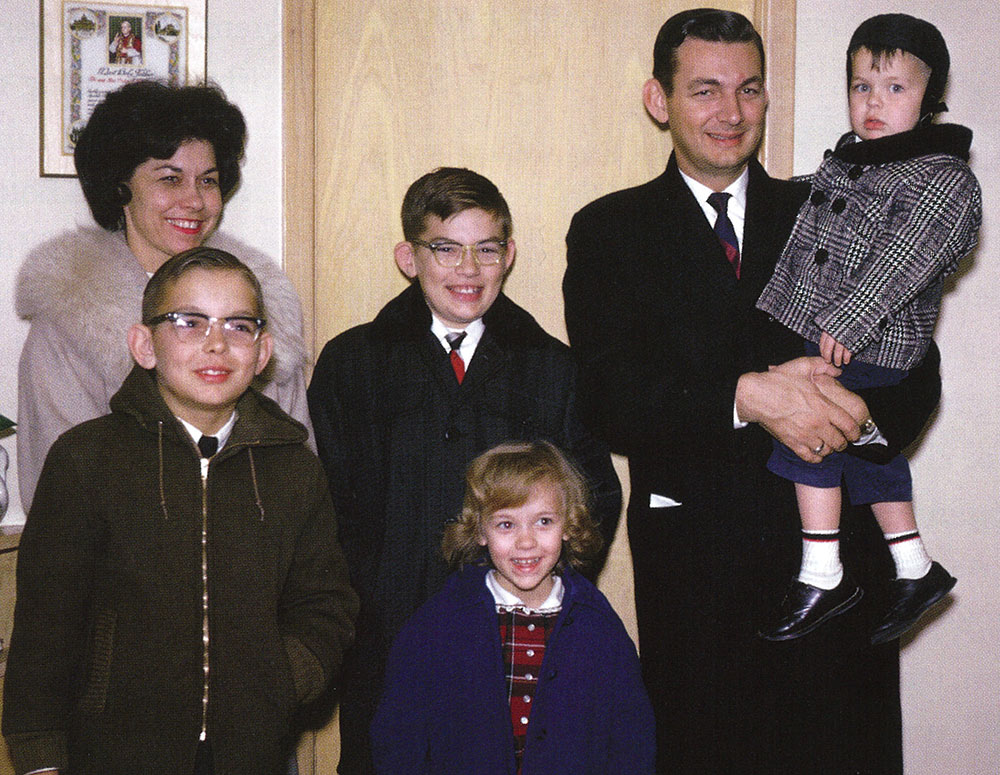 Virgil and Ann Dechant stand smiling with their children, Dan, Tom, Karen and Bobby, circa 1964.