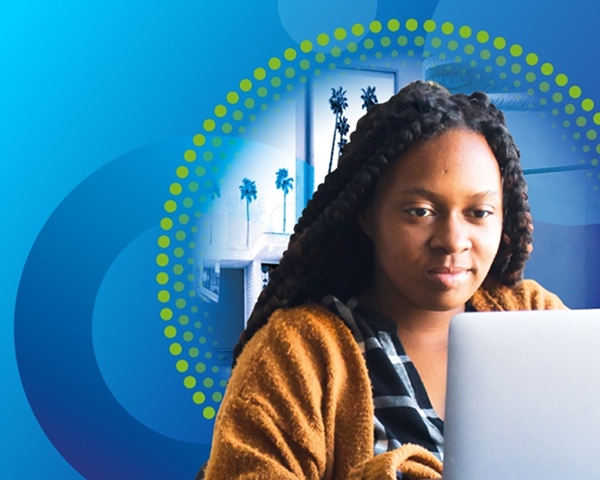 A young woman with long, dark braids, wearing an orange cardigan and plaid shirt, looks intently at a laptop screen. The image has a blue background with a large, dotted green and yellow circular graphic overlay.