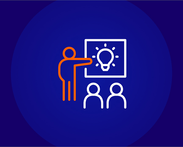 A line icon on a dark blue background showing an orange-outlined person pointing at a screen with a white lightbulb icon on it, presenting to two white-outlined figures sitting below, symbolizing teaching or presenting a new idea.