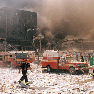 New York City firefighters and other emergency personnel survey the World Trade Center collapse Sept. 11, 2001.