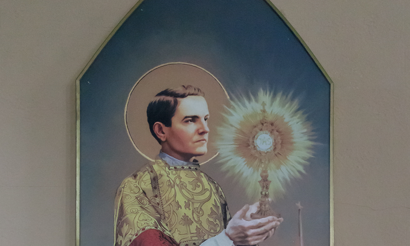 A painting of Father Michael J. McGivney lifting a monstrance with the Blessed Sacrament, at Immaculate Conception Church, Terryville, CT.